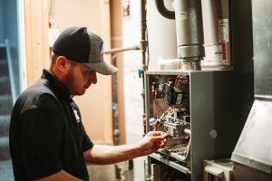 HVAC-technician-inspecting-furnace