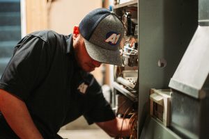 A1-technician-repairing-a-furnace